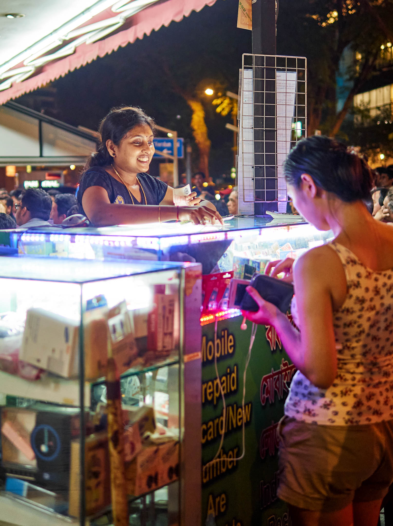 A woman vendor selling mobile phone cards, Kitchener Road, Singapore