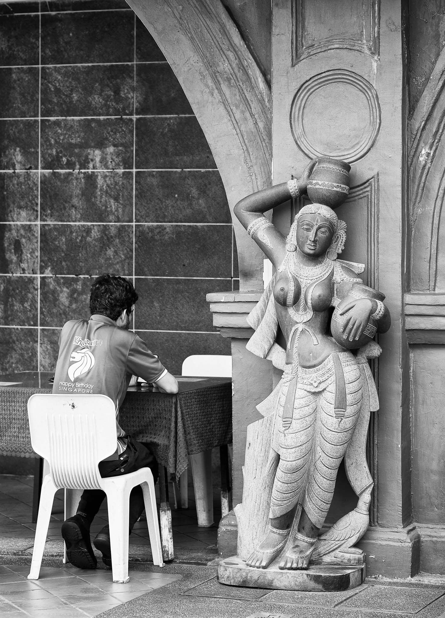 A statue of woman fetching water situated at a roadside restaurant, Serangoon Road, Singapore