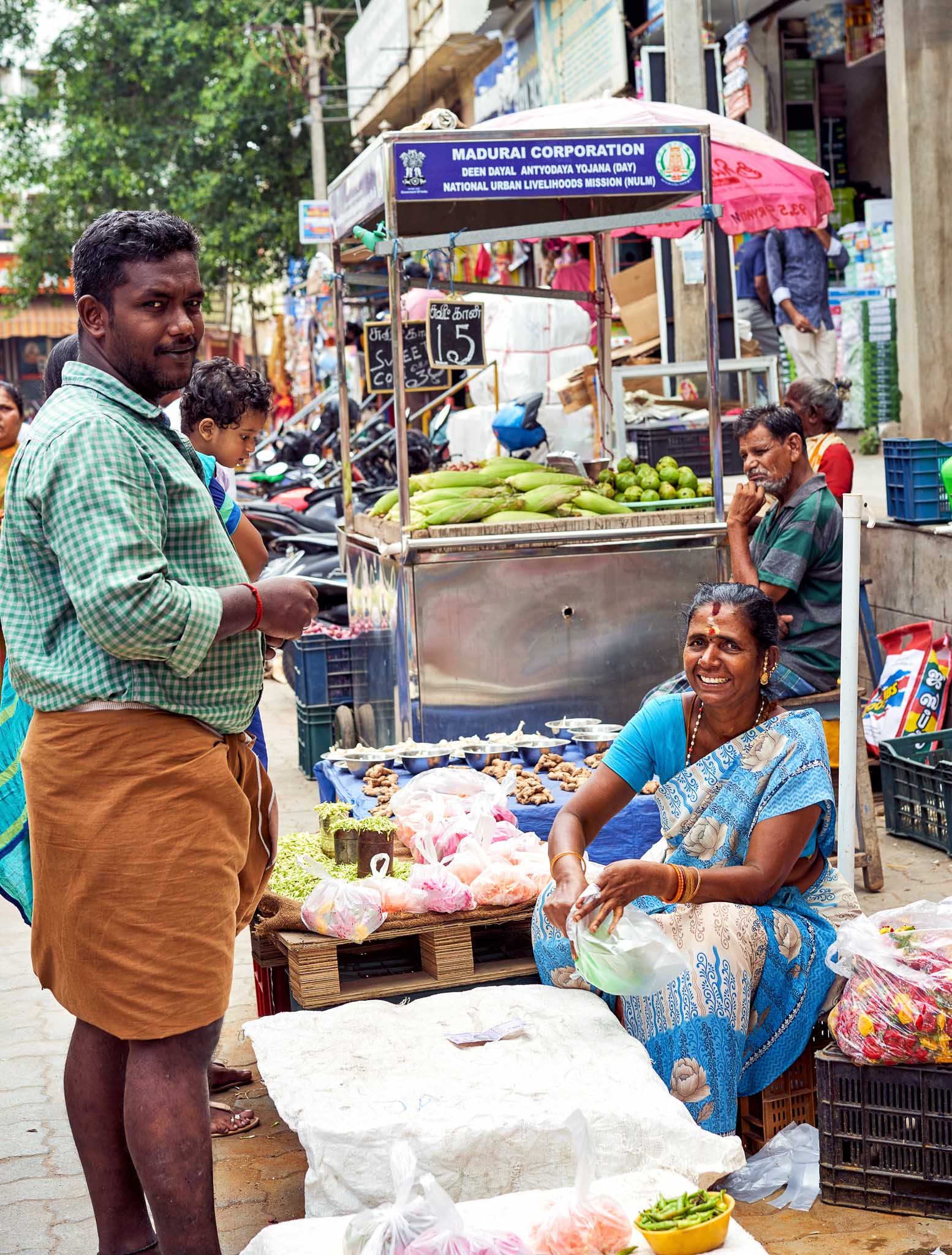 A woman flower seller at her street side shop, Madurai, Tamil Nadu, India